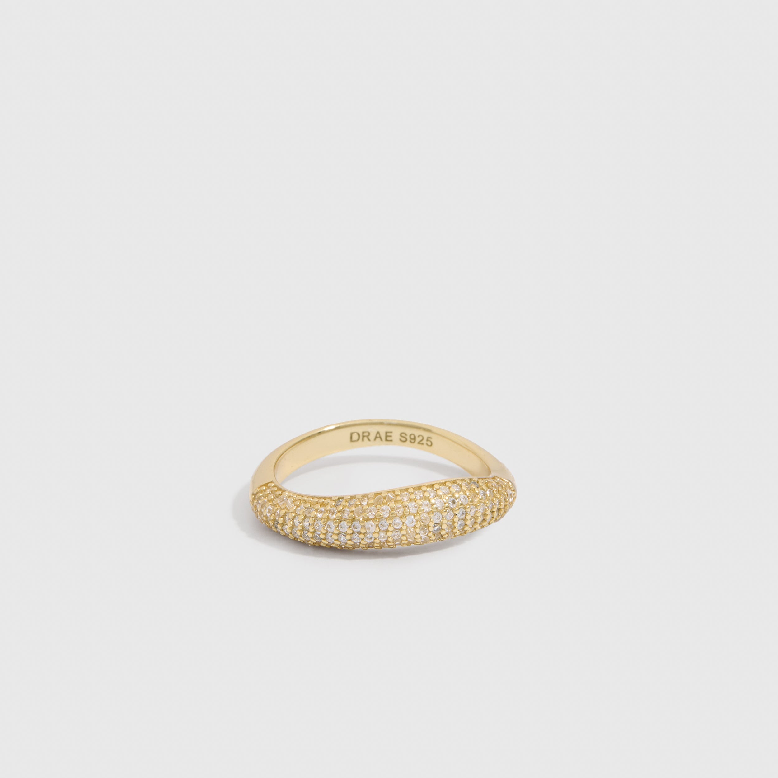 14k gold plated wavy pavé ring with round-cut cubic zirconia set edge to edge, shown on a plain background.
