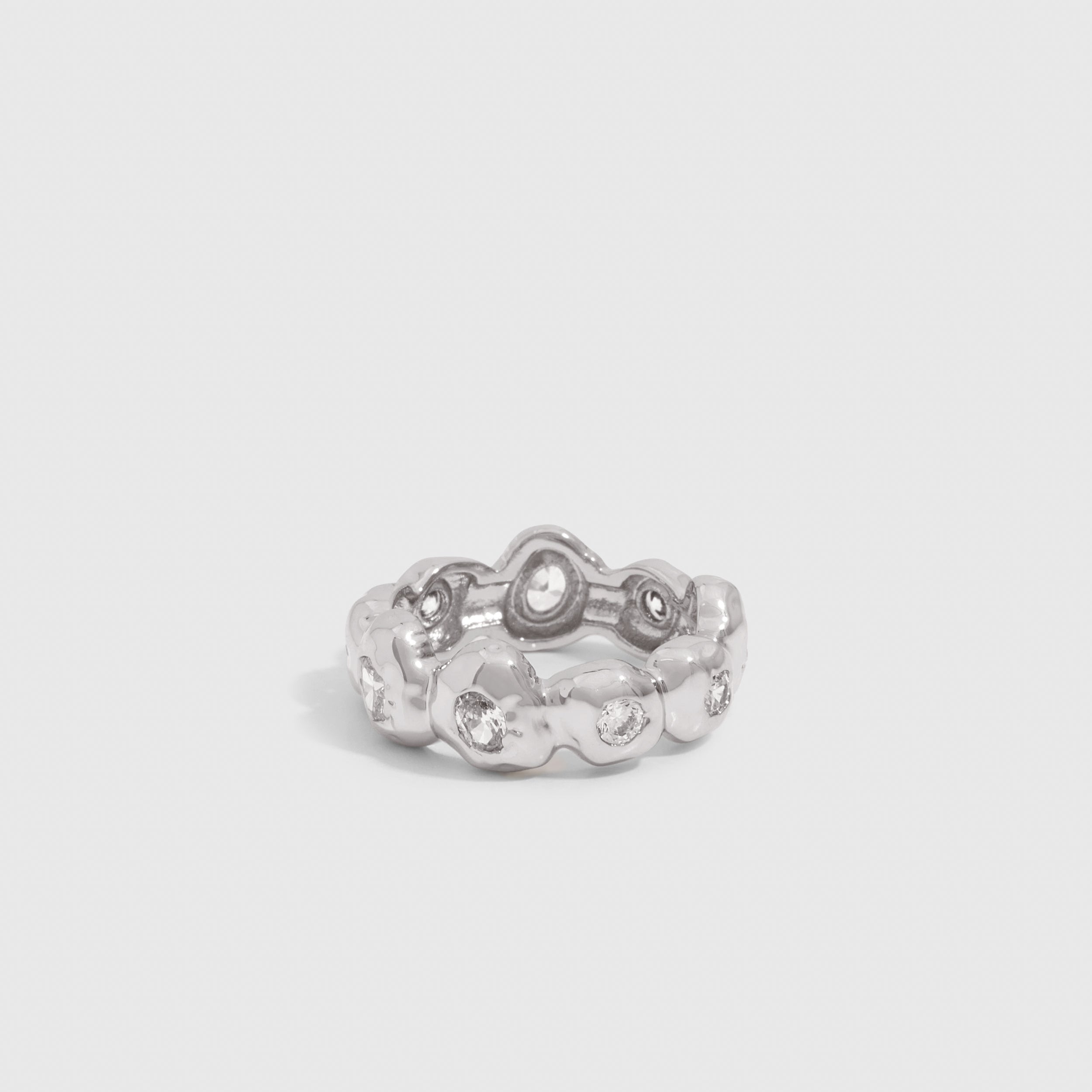 Silver nugget ring with cubic zirconia set among textured beads, shown on a plain background.