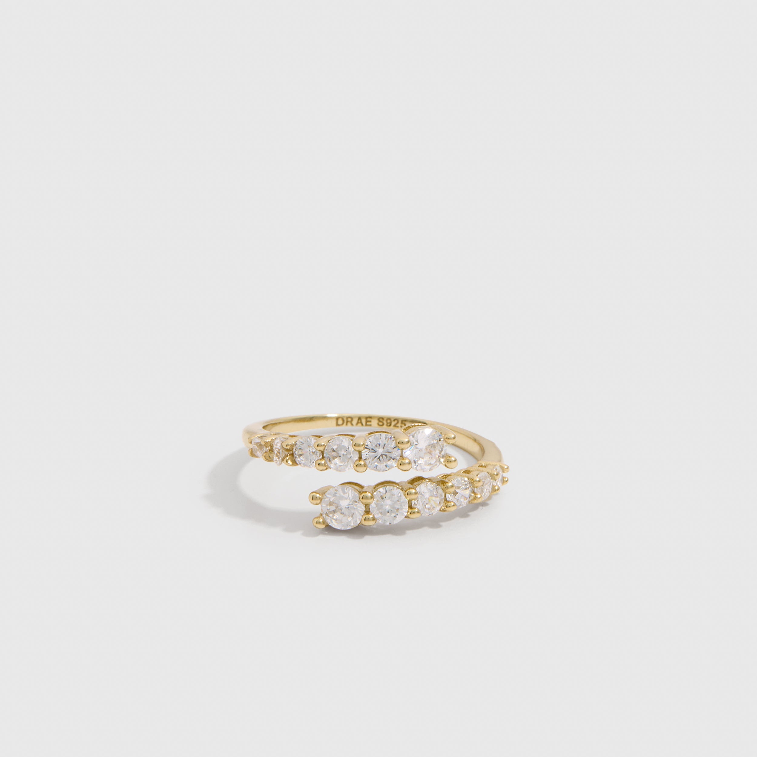 14k gold plated graduated cubic zirconia wrap ring with four stone sizes tapering across the band, shown on a plain background.