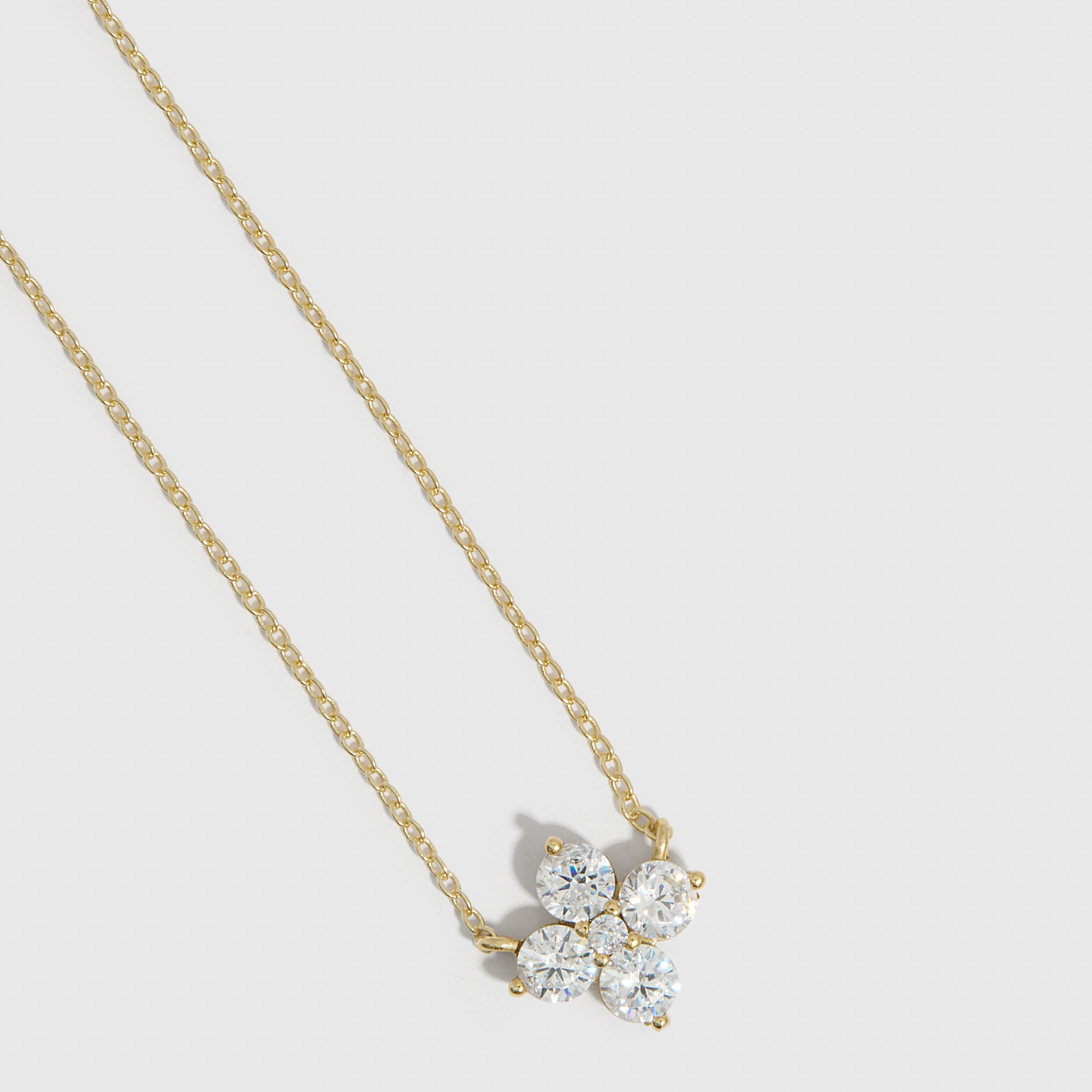 14k gold plated clover motif pendant necklace with cubic zirconia detailing on a cable chain, shown on a plain background.