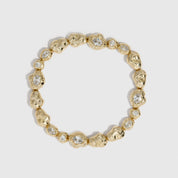 14k gold plated nugget tennis bracelet with cubic zirconia nuggets in two sizes, shown on a plain background.