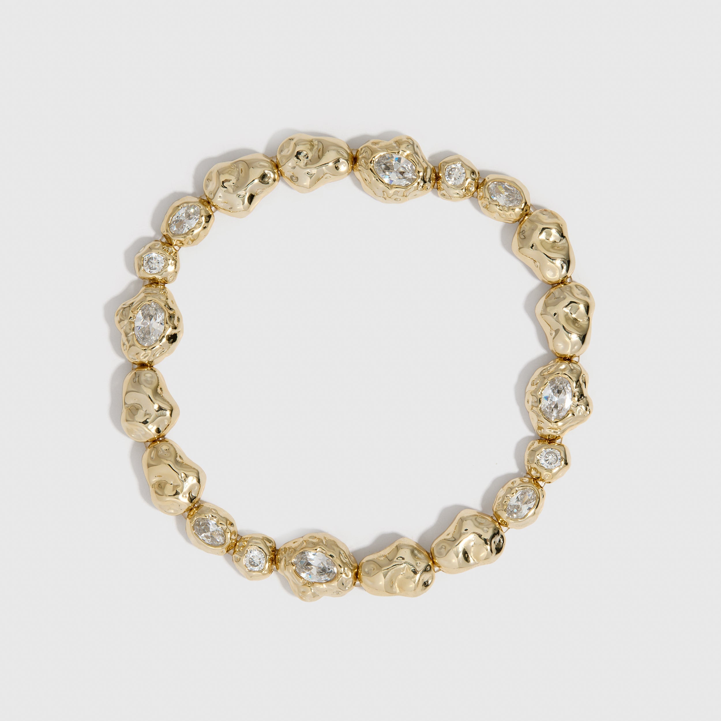 14k gold plated nugget tennis bracelet with cubic zirconia nuggets in two sizes, shown on a plain background.