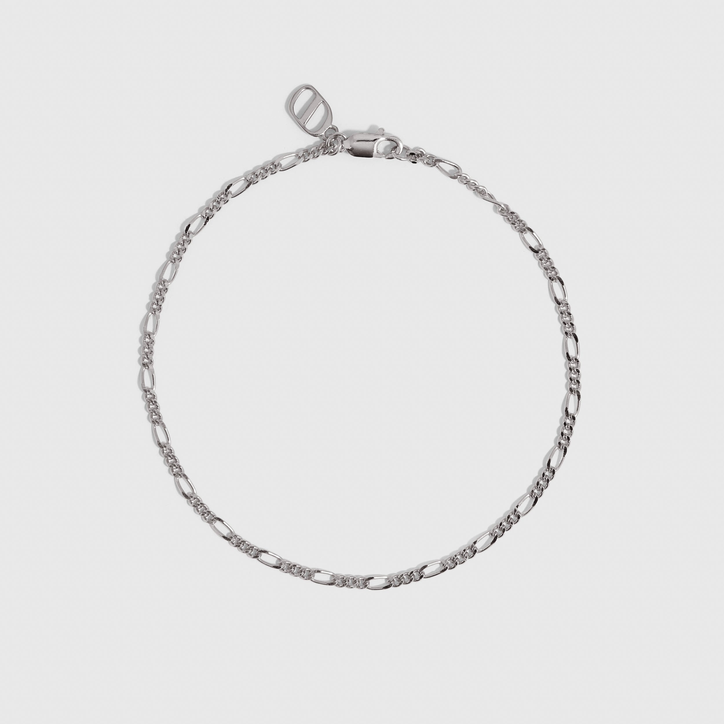 Silver Figaro link chain bracelet, shown on a plain background.