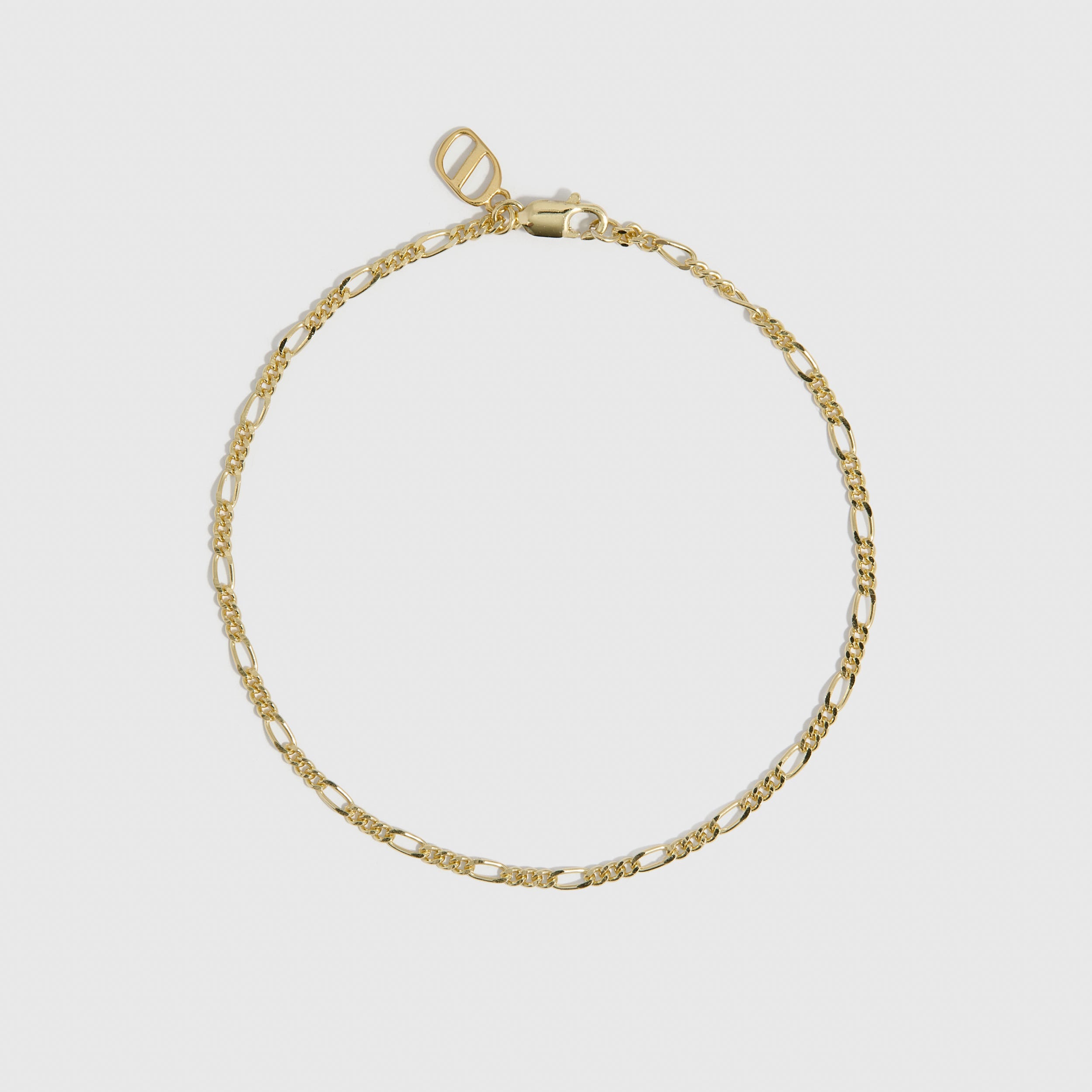 14k gold plated Figaro link chain bracelet, shown on a plain background.