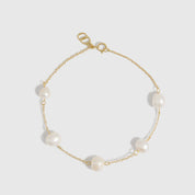 14k gold plated bracelet with genuine freshwater pearls strung along a fine chain, shown on a plain background.