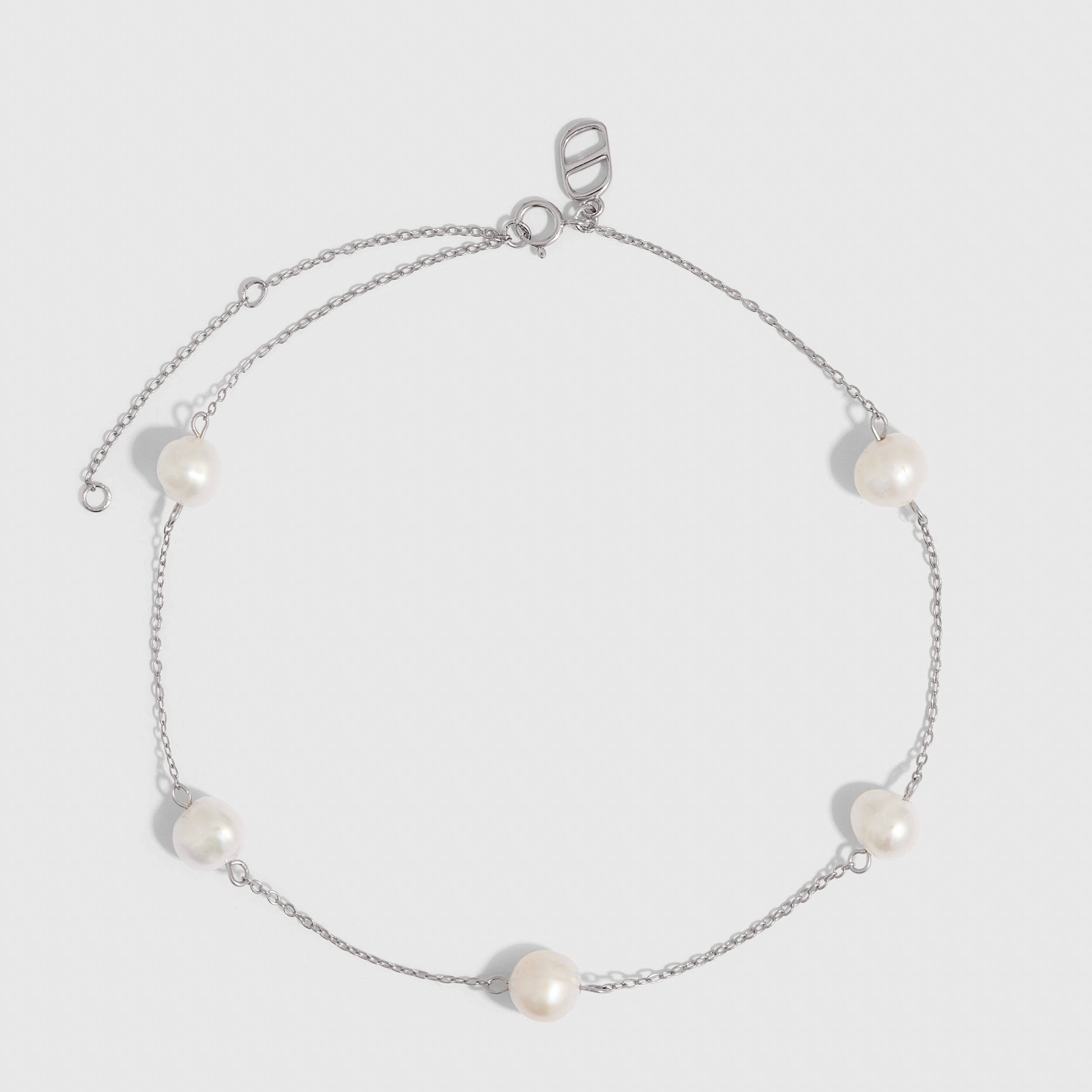 Silver anklet with genuine freshwater pearls strung along a fine chain, shown on a plain background.