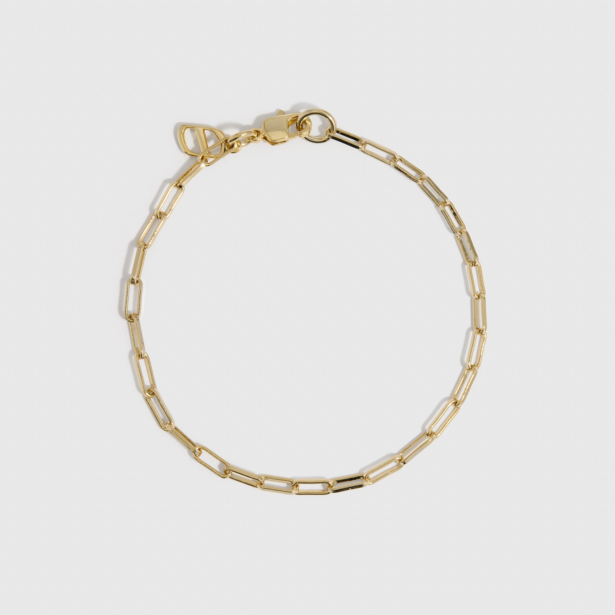 14k gold plated paper clip link chain bracelet, shown on a plain background.