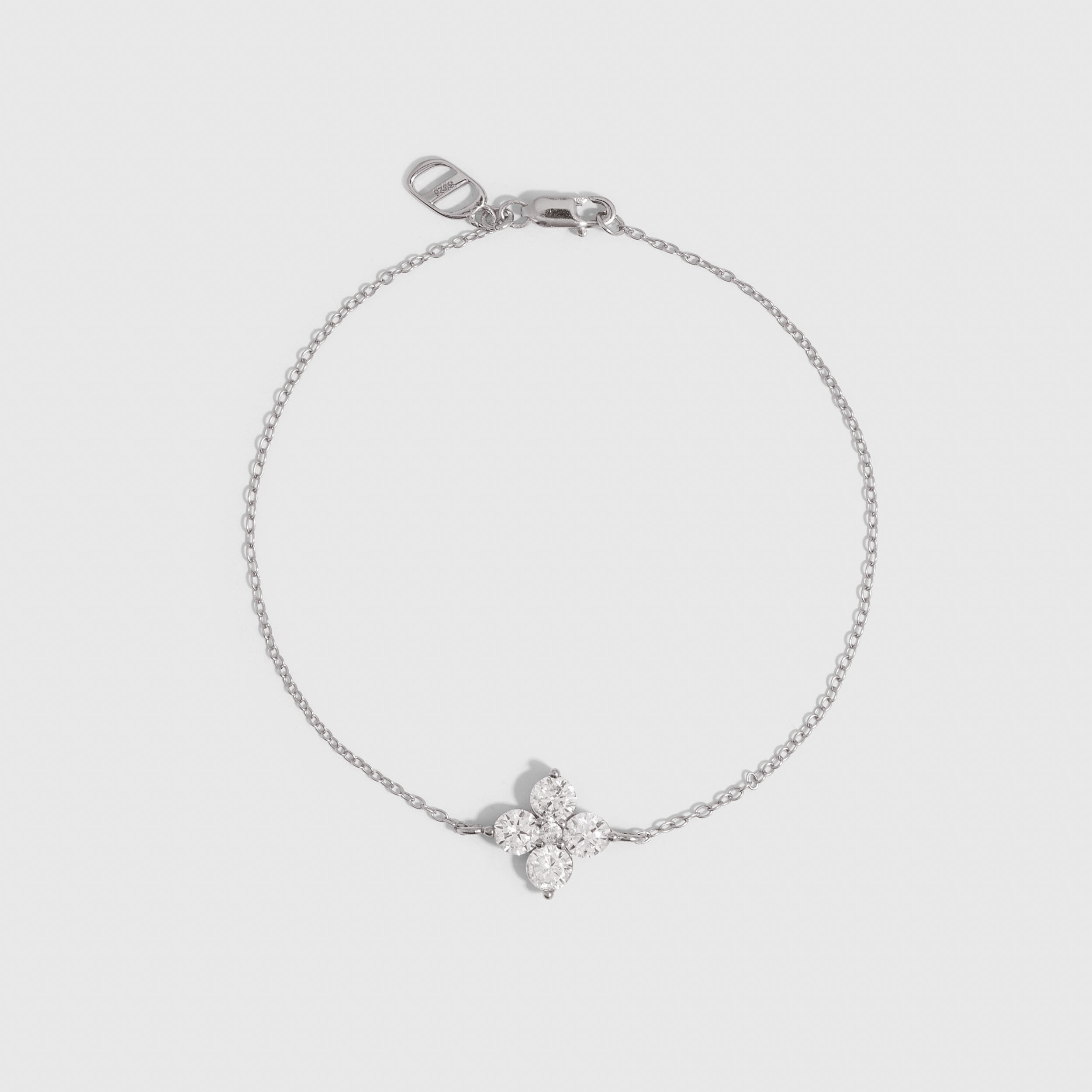 Silver clover motif chain bracelet with cubic zirconia detailing, shown on a plain background.