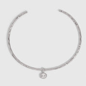 Silver hammered neck cuff necklace with a detachable cubic zirconia charm, shown on a plain background.
