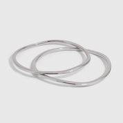 Silver duo bangle bracelet set with a wavy, textured finish, shown on a plain background.