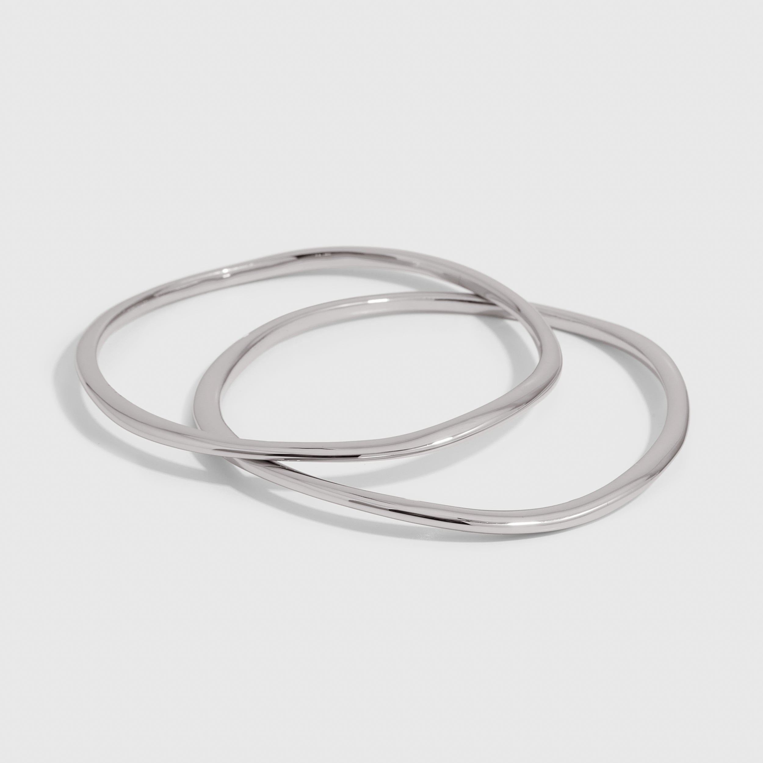 Silver duo bangle bracelet set with a wavy, textured finish, shown on a plain background.