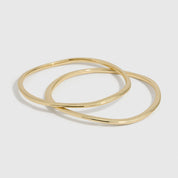 14k gold plated duo bangle bracelet set with a wavy, textured finish, shown on a plain background.