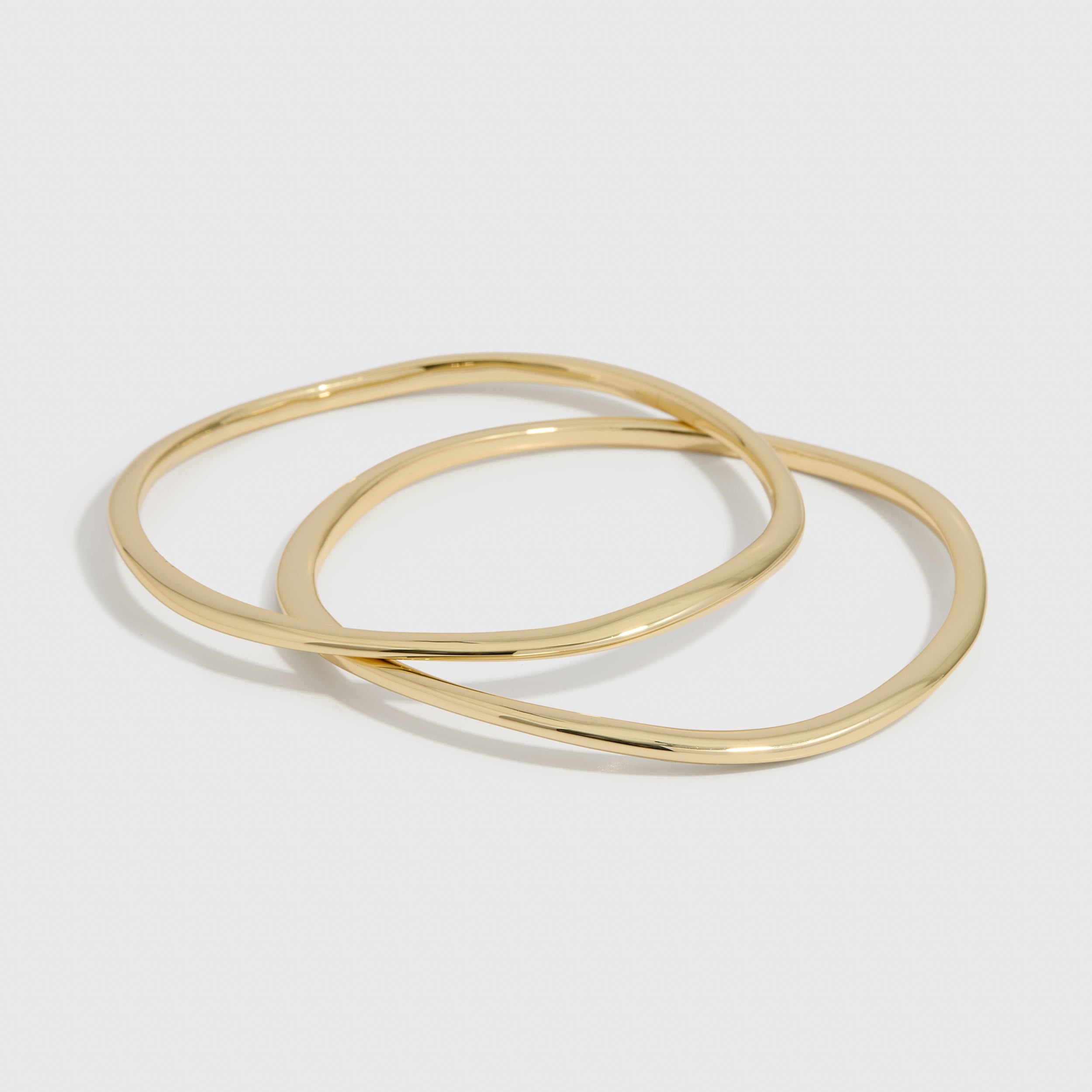 14k gold plated duo bangle bracelet set with a wavy, textured finish, shown on a plain background.