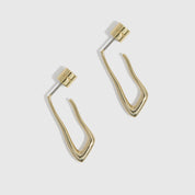 14k gold plated organic-shaped drop hoop earrings shown on a plain background, highlighting their fluid silhouette.