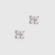 Silver clover motif stud earrings with cubic zirconia detailing, shown on a plain background.