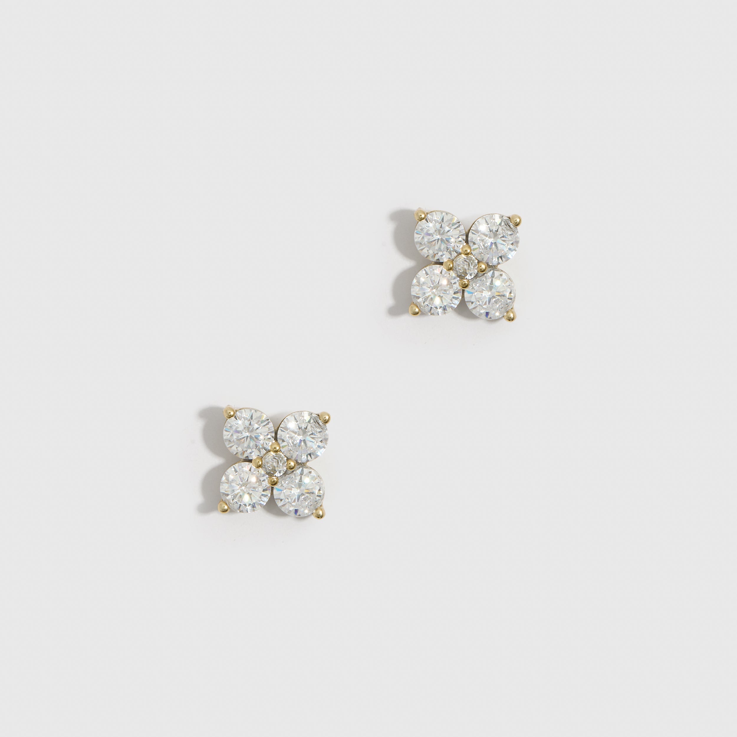 14k gold plated clover motif stud earrings with cubic zirconia detailing, shown on a plain background.