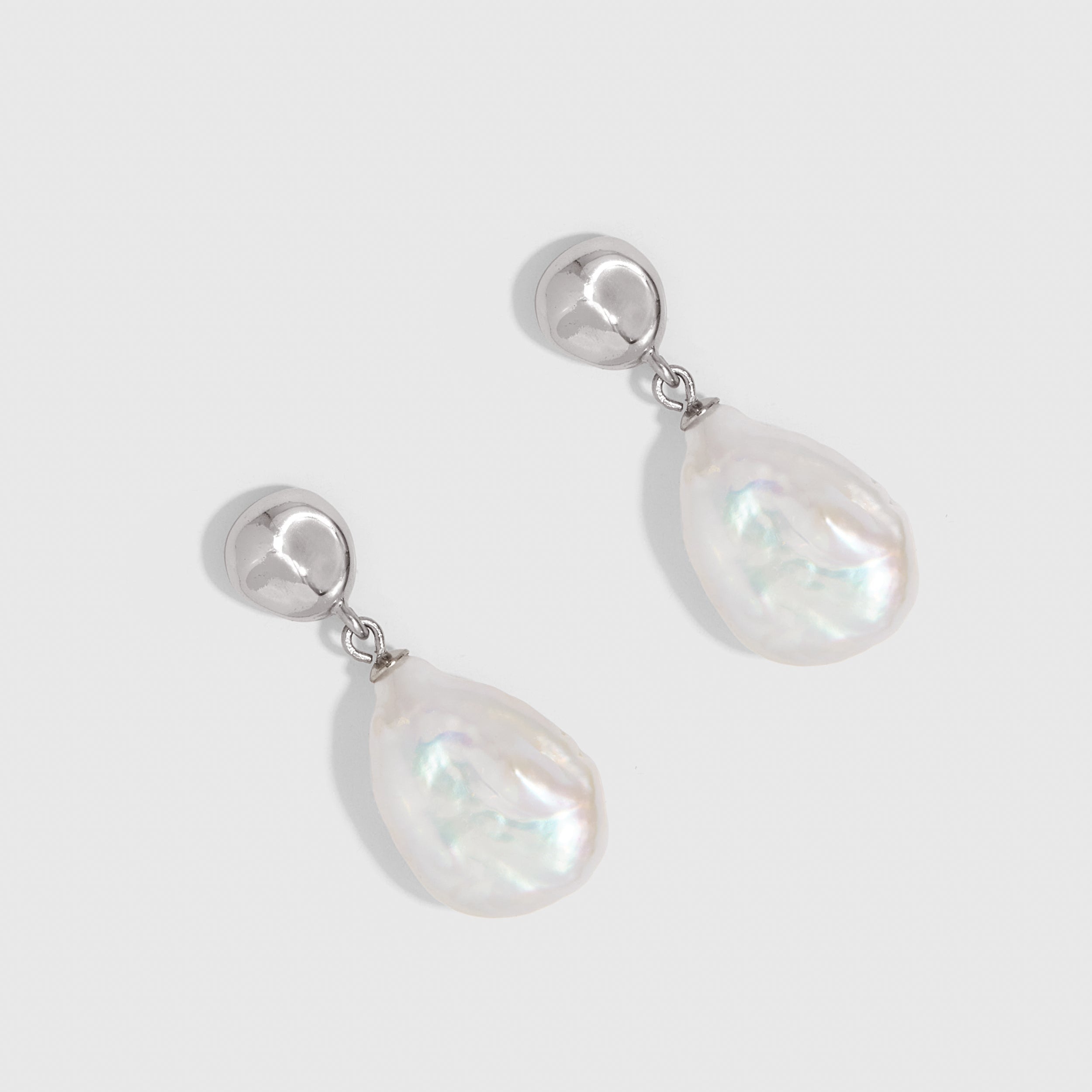 Silver pendant earrings with a genuine irregular baroque pearl drop, shown on a plain background.