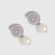 Silver seashell stud earrings cradling a genuine freshwater pearl, shown on a plain background.