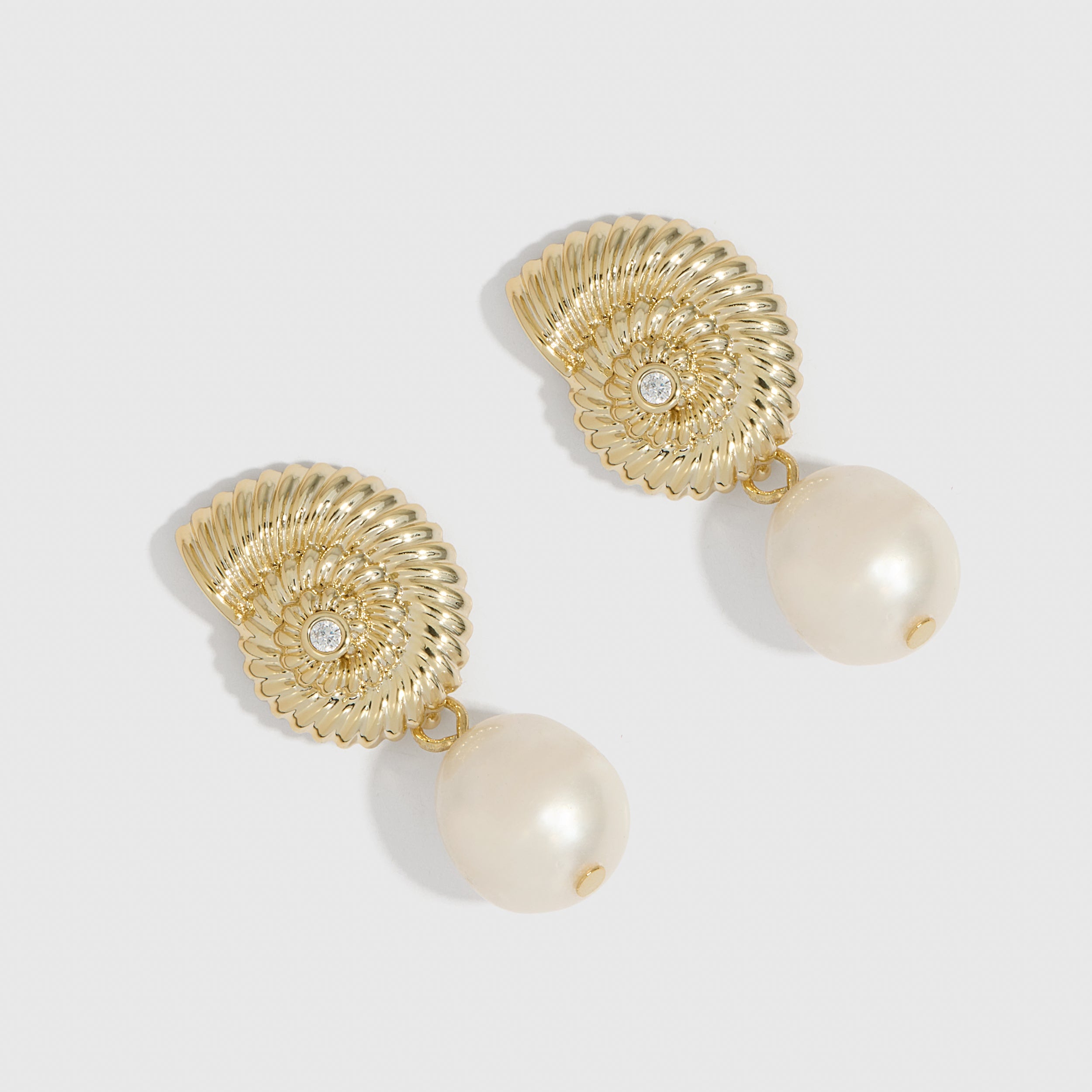 14k gold plated seashell stud earrings cradling a genuine freshwater pearl, shown on a plain background.