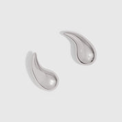 Silver sculptural water-drop shaped stud earrings, shown on a plain background.