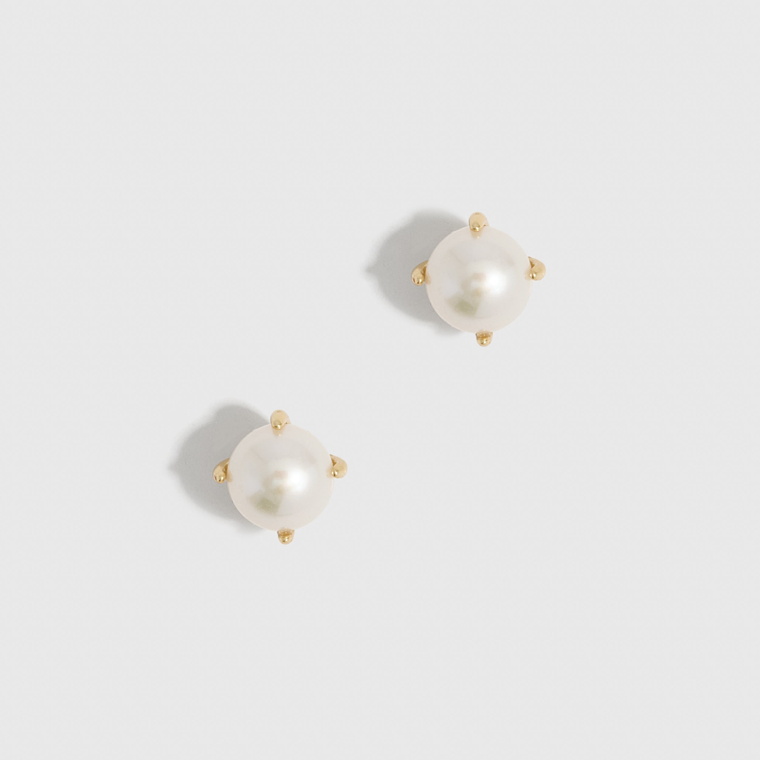 14k gold plated stud earrings with a genuine round freshwater pearl, shown on a plain background.