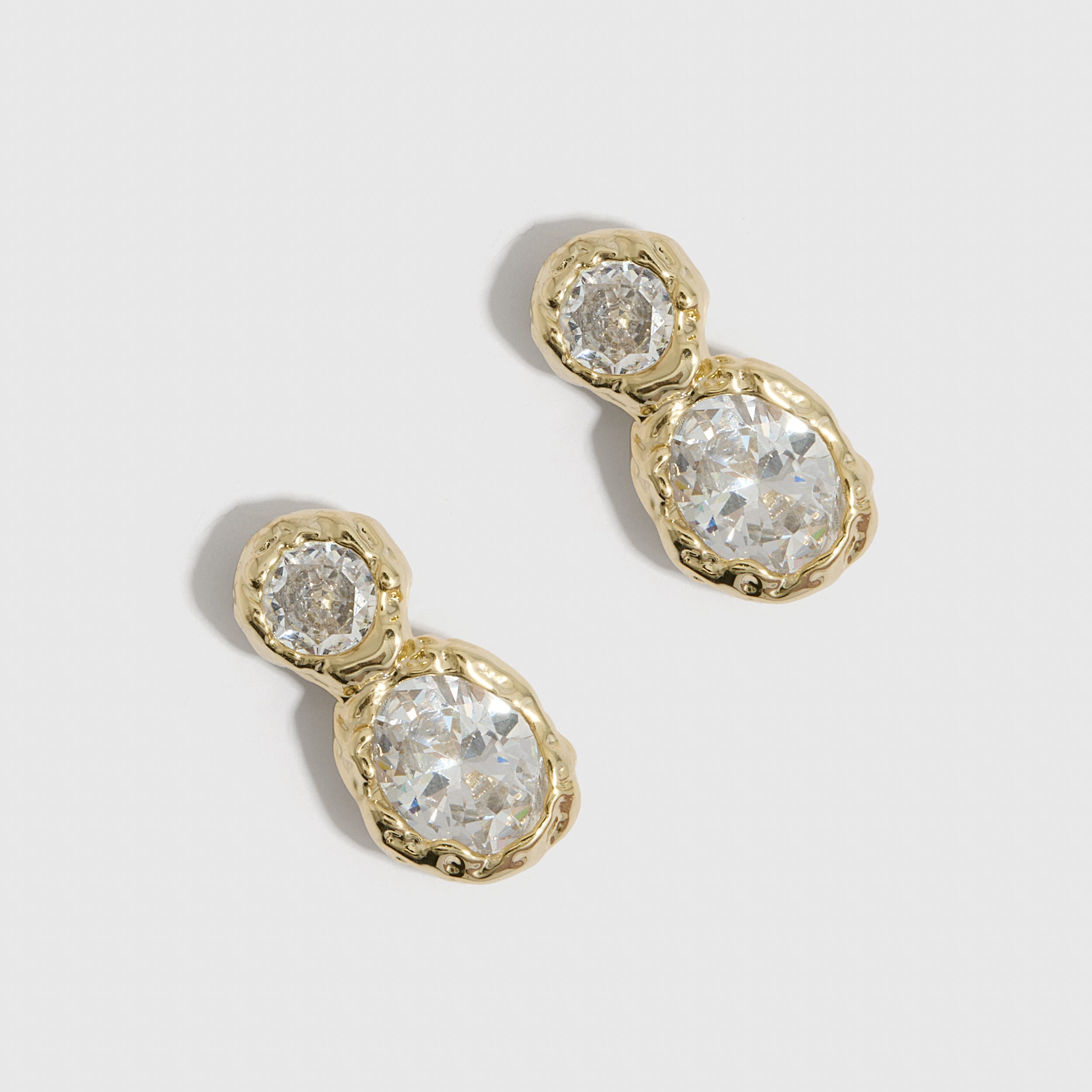14k gold plated drop earrings with round-cut and oval-cut cubic zirconia, shown on a plain background.