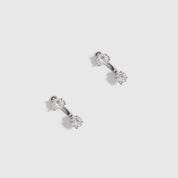 Silver round-cut cubic zirconia barbell stud earrings, shown on a plain background.