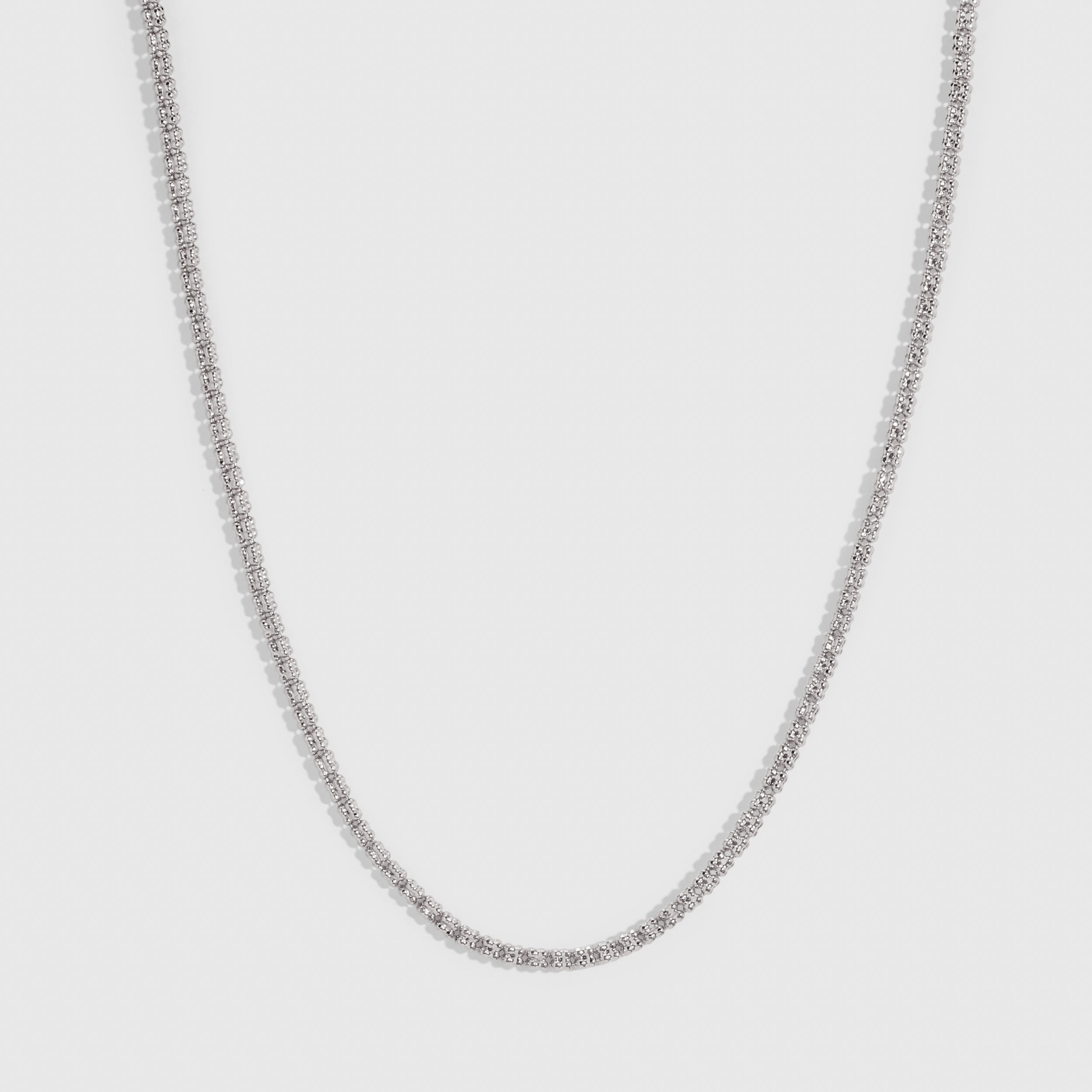 Silver popcorn-link chain necklace showing its twisted, textured profile, shown on a plain background.