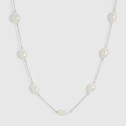 Silver necklace with genuine baroque pearls of varied irregular shapes, shown on a plain background.