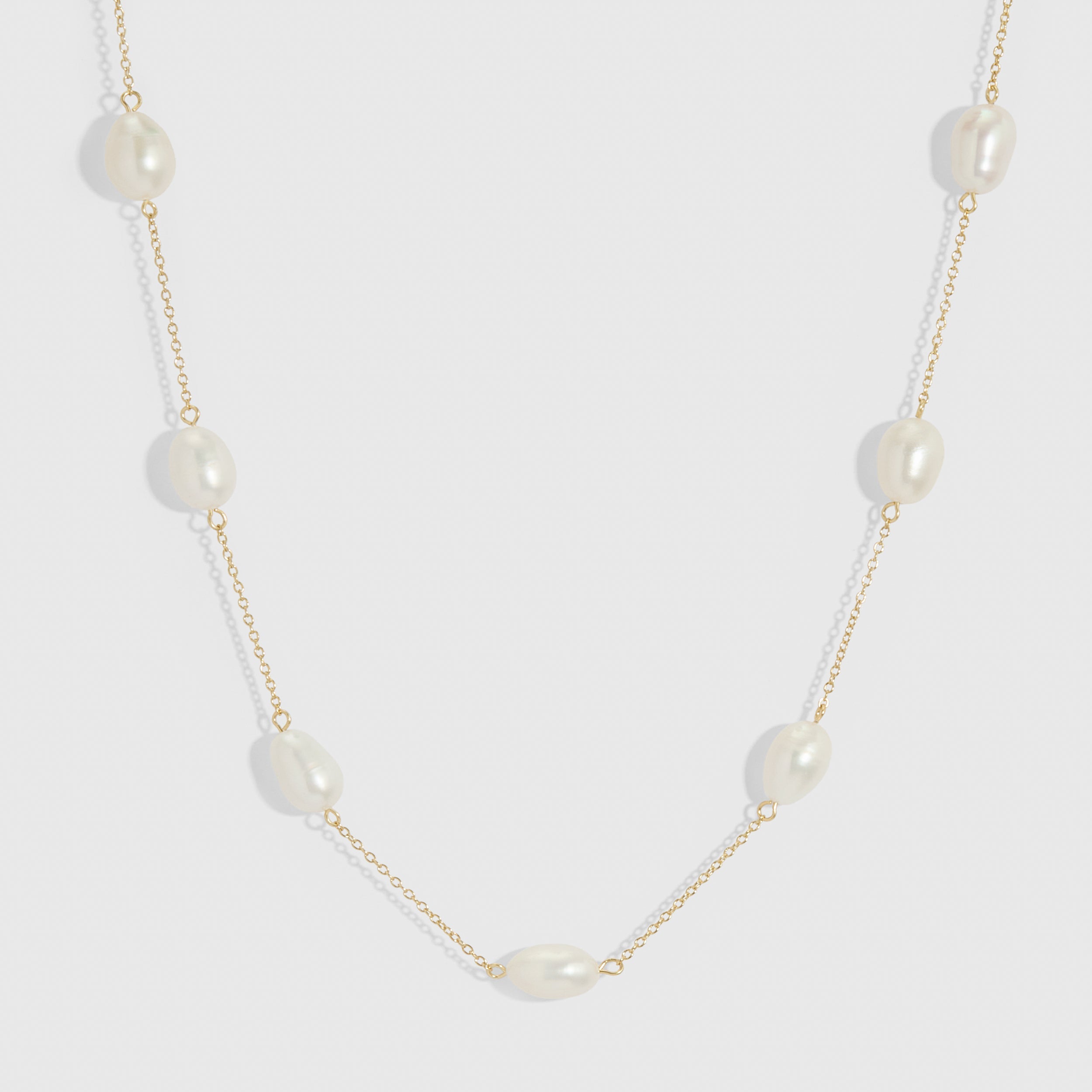 14k gold plated necklace with genuine baroque pearls of varied irregular shapes, shown on a plain background.