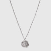 Silver seashell pendant necklace with a teardrop-cut cubic zirconia, shown on a plain background.