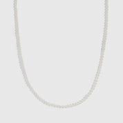 Silver glass pearl necklace with small round pearls on a curb chain, shown on a plain background.