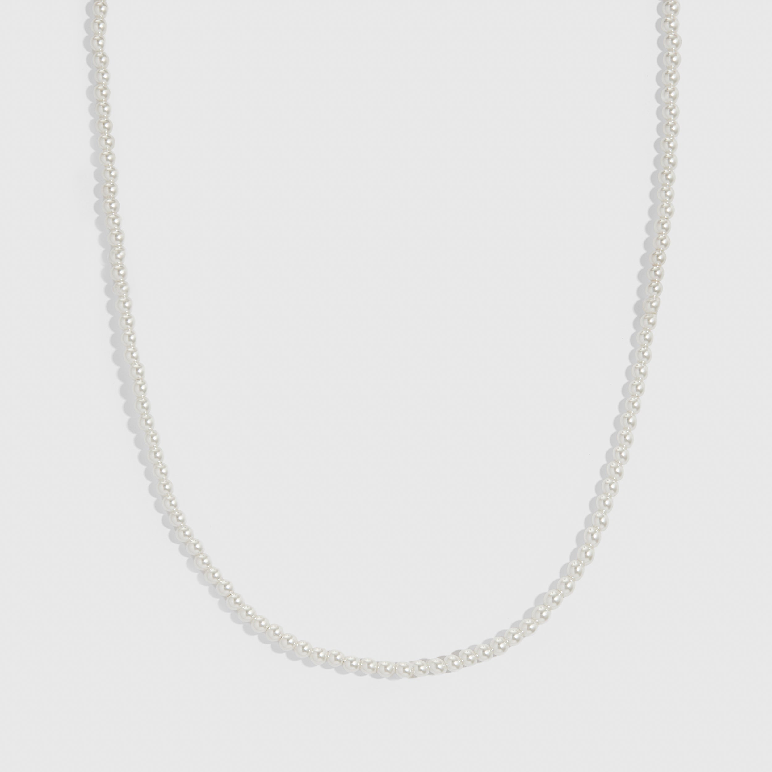 Silver glass pearl necklace with small round pearls on a curb chain, shown on a plain background.