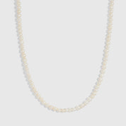 14k gold detailed necklace with genuine round freshwater pearls on a fabric cord, shown on a plain background.