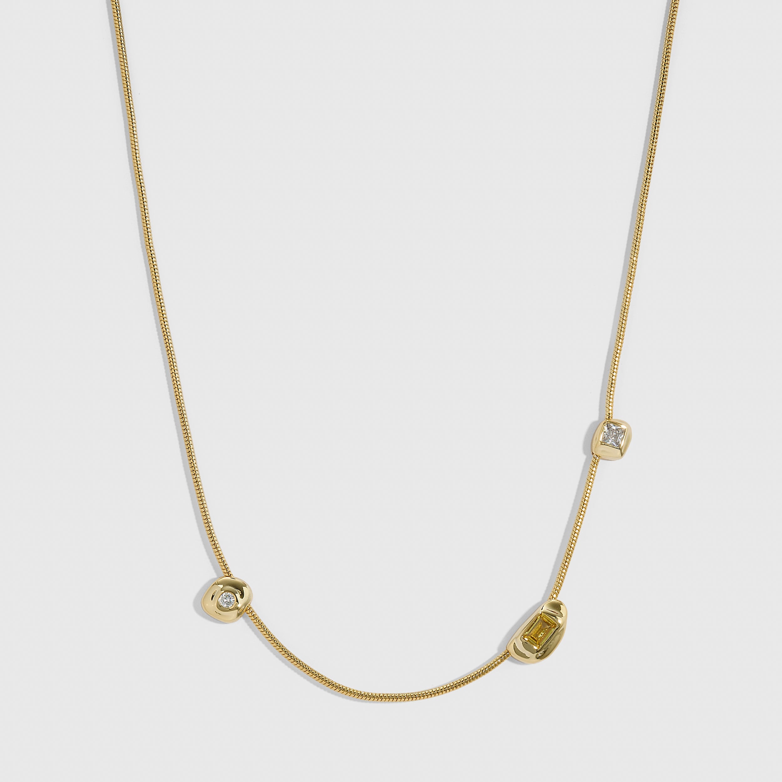 14k gold plated trio pendant necklace with three organic bezels holding mixed cubic zirconia and citrine stones, shown on a plain background.