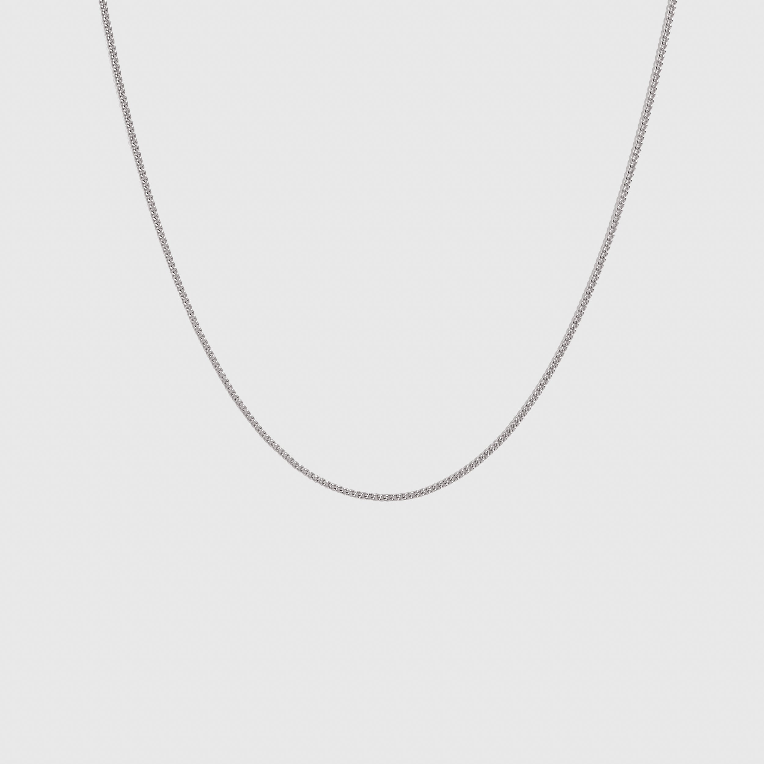 Silver flat curb chain necklace, shown on a plain background.