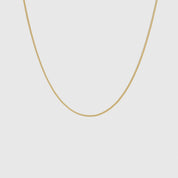 14k gold plated flat curb chain necklace, shown on a plain background.