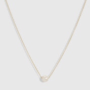 14k gold plated solitaire pendant necklace with one round freshwater pearl on a fine cable chain, shown on a plain background.