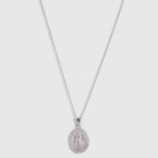 Silver Virgin Mary pendant necklace with pavé cubic zirconia edging on a fine cable chain, shown on a plain background.
