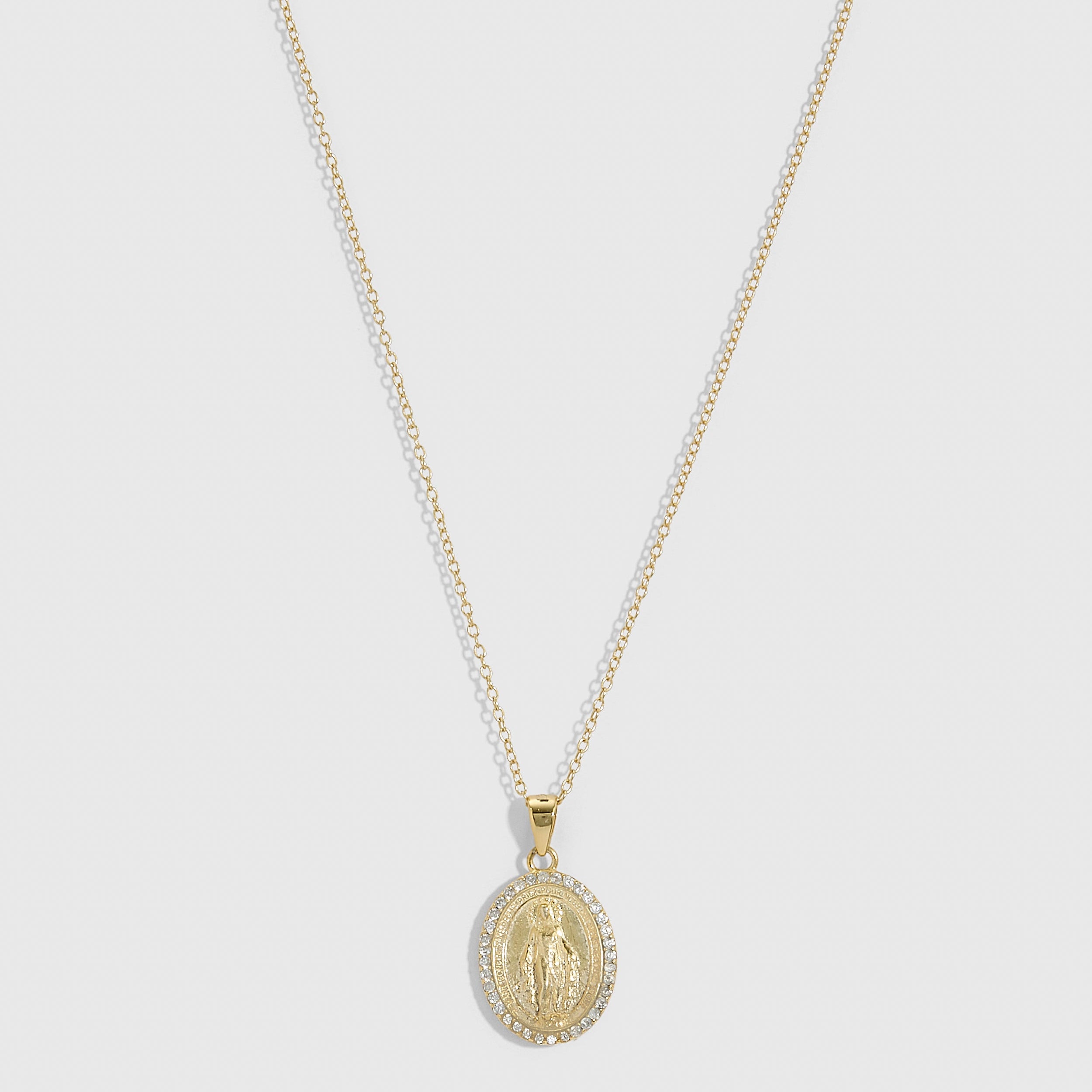 14k gold plated Virgin Mary pendant necklace with pavé cubic zirconia edging on a fine cable chain, shown on a plain background.
