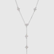 Silver multi-clover lariat necklace with cubic zirconia detailing and a draped chain, shown on a plain background.