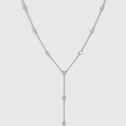 Silver bezel-set cubic zirconia lariat necklace with a draped adjustable chain, shown on a plain background.