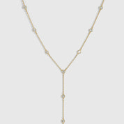 14k gold plated bezel-set cubic zirconia lariat necklace with a draped adjustable chain, shown on a plain background.