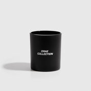 DRAE Collection sandalwood scented candle in a glass jar, shown on a plain background.