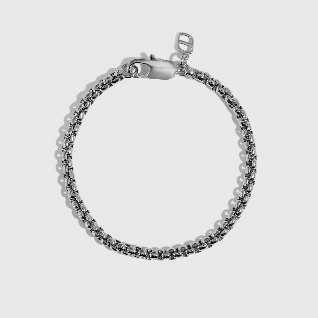 Silver plated men's round box chain bracelet, shown on a plain background.