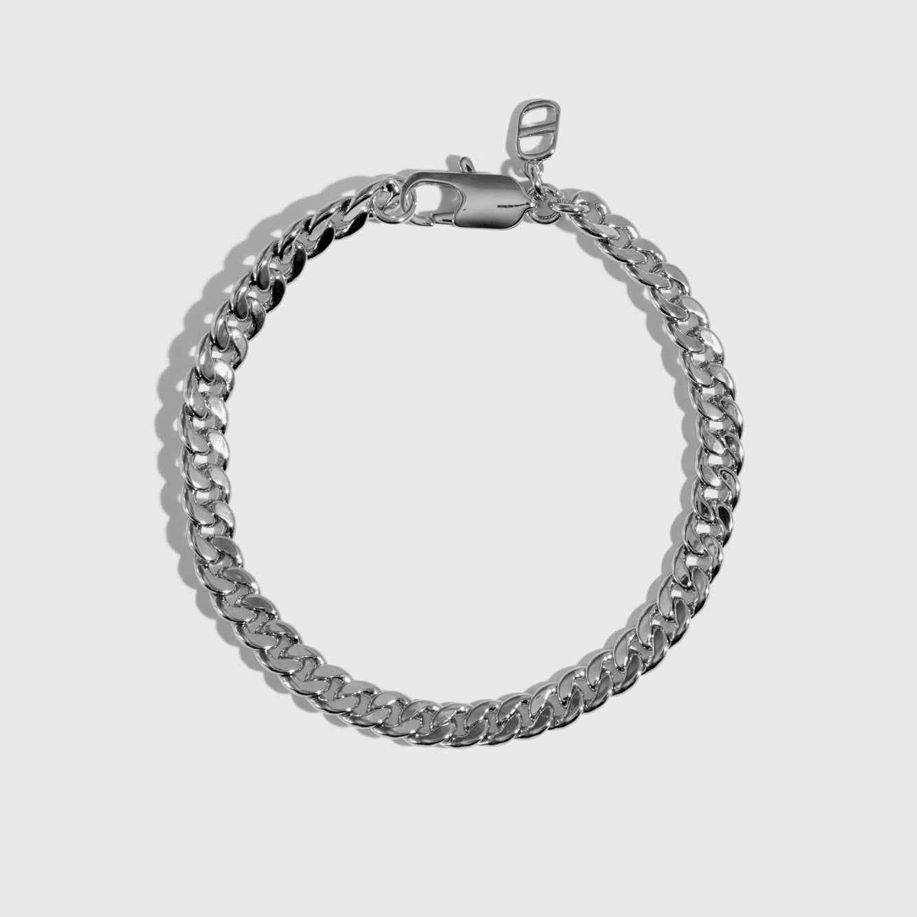 Silver plated men's curb chain bracelet, shown on a plain background.