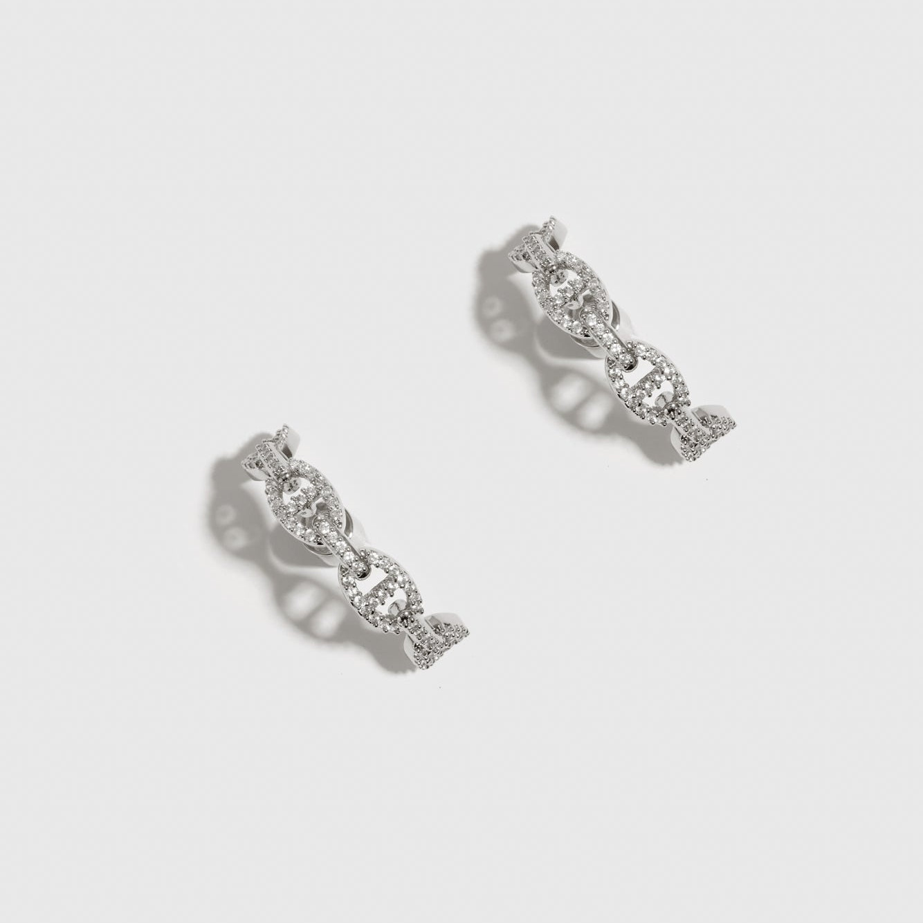 Silver plated mariner pavé earrings with cubic zirconia, shown on a plain background.