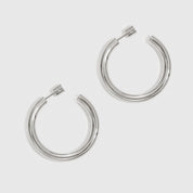 Silver plated small hollow hoop earrings, shown on a plain background.