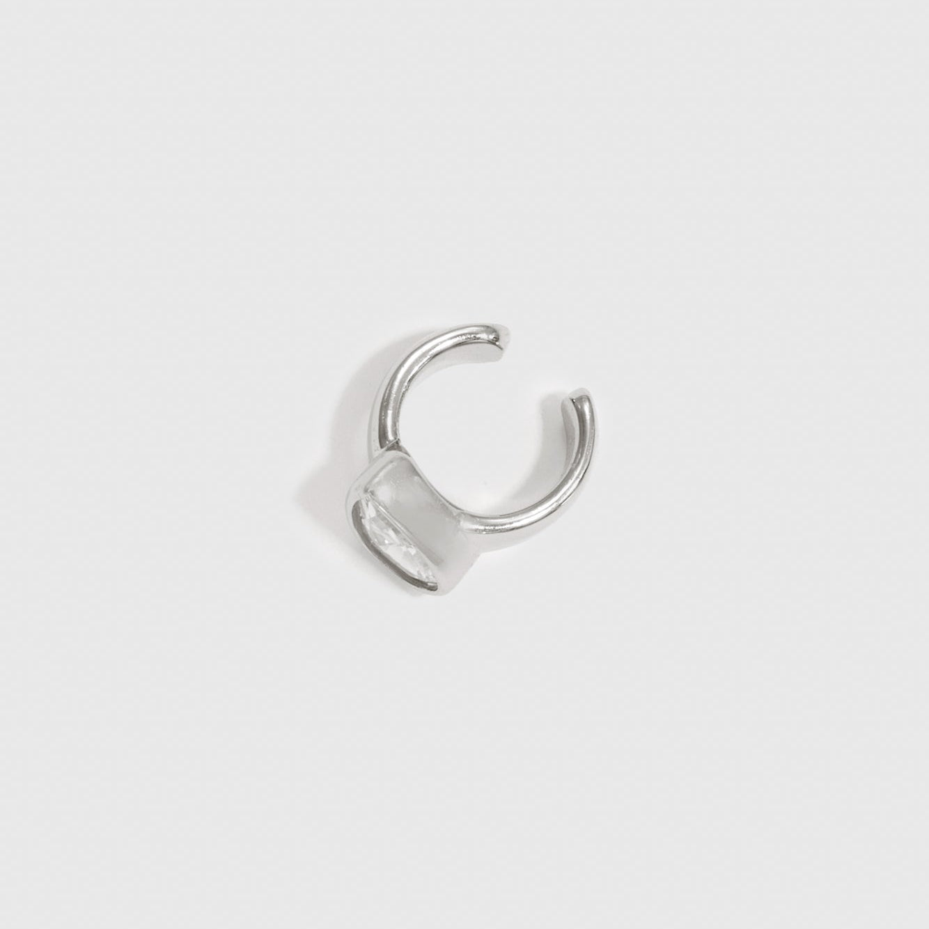 Sterling silver 925 teardrop-cut solitaire ear cuff with a cubic zirconia, shown on a plain background.