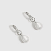 Sterling silver 925 baroque pearl huggie earrings with baroque pearls, shown on a plain background.